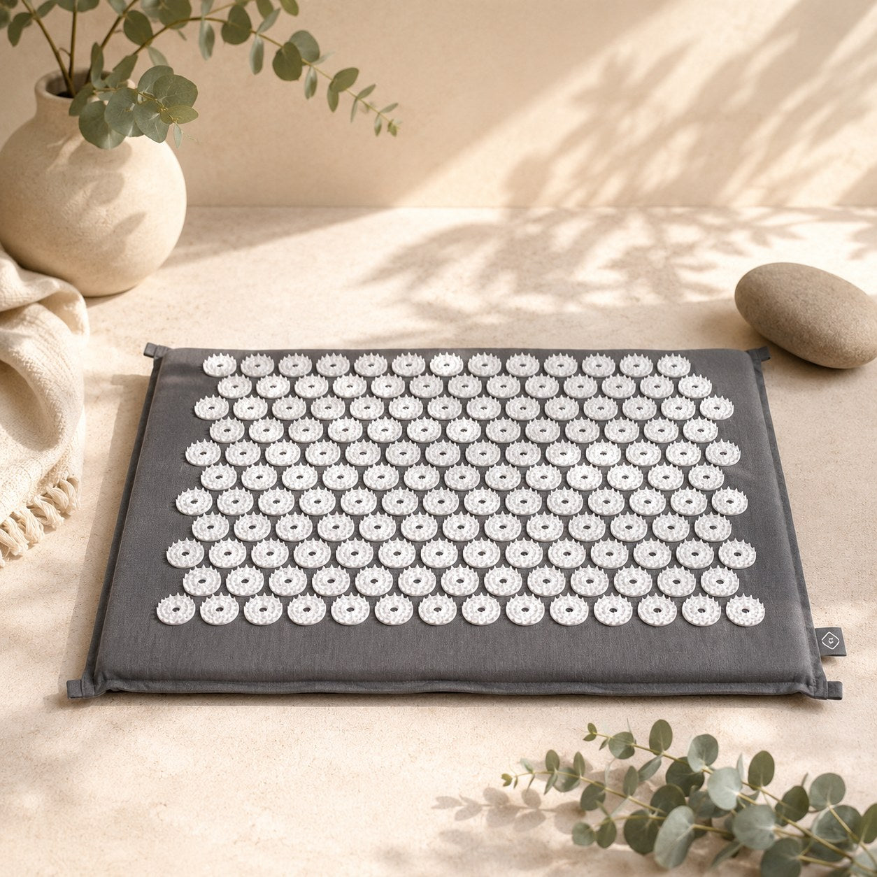 SOMA acupressure mat flat lay with eucalyptus